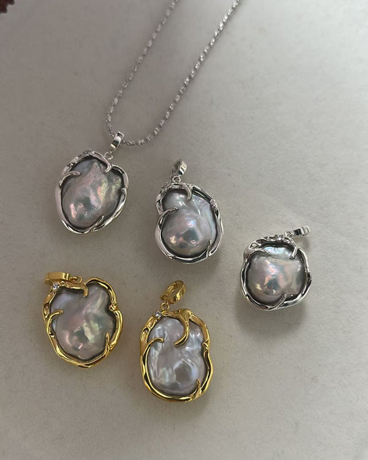 Set of pearl jewelry pieces with gold and silver accents on a white background