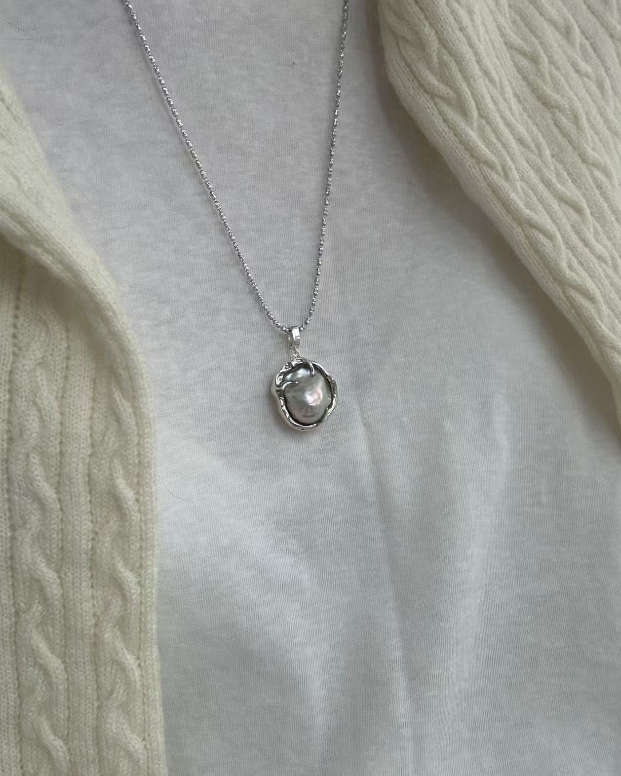 Necklace with a pendant on a light gray background