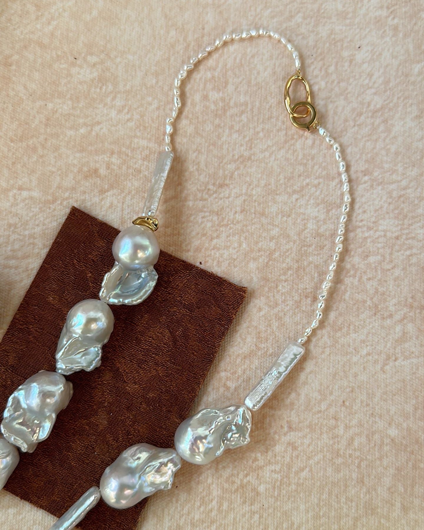 Beaded hair accessory with pearls on a beige background