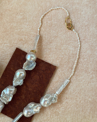 Beaded hair accessory with pearls on a beige background