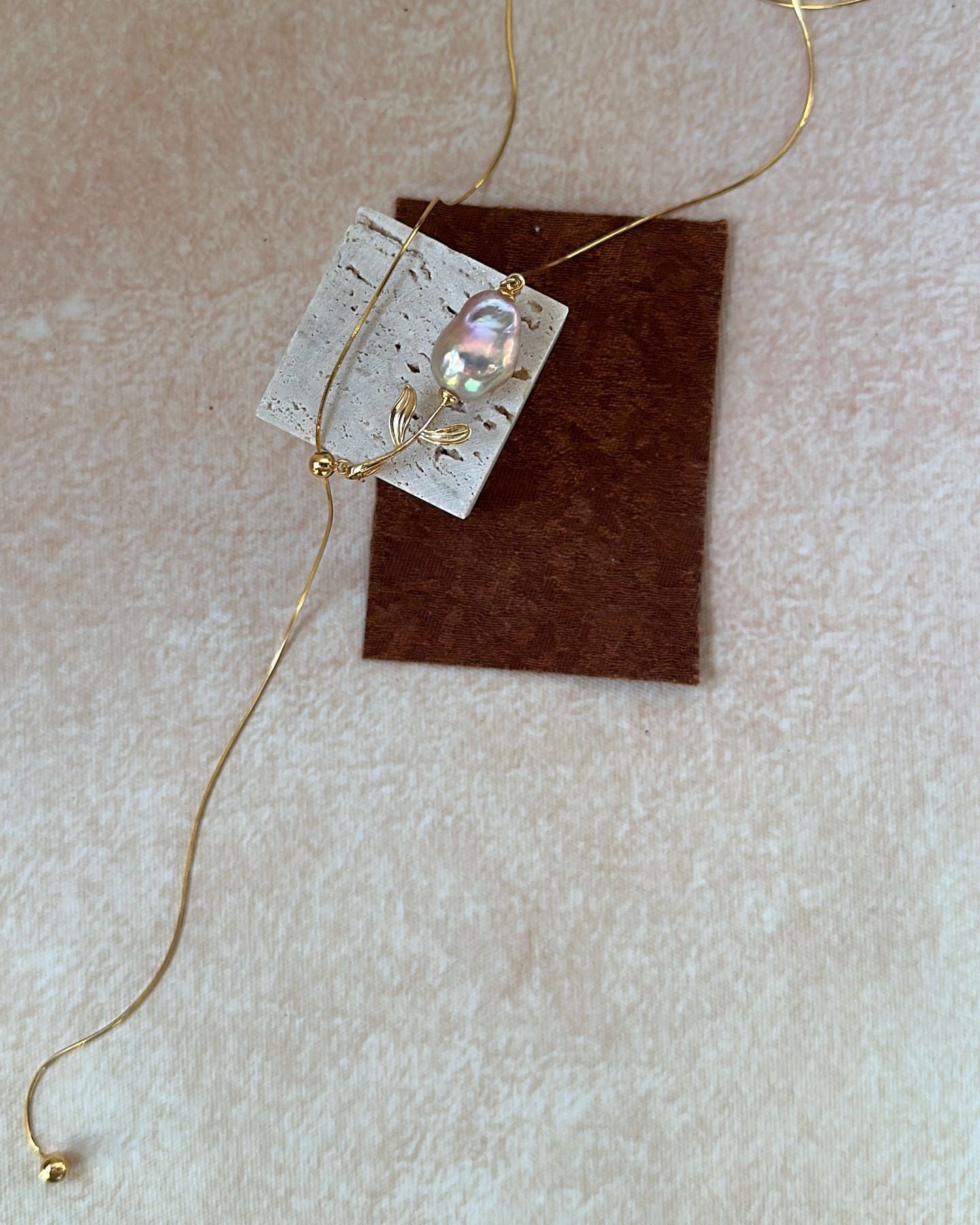 Necklace with a pendant on a beige background