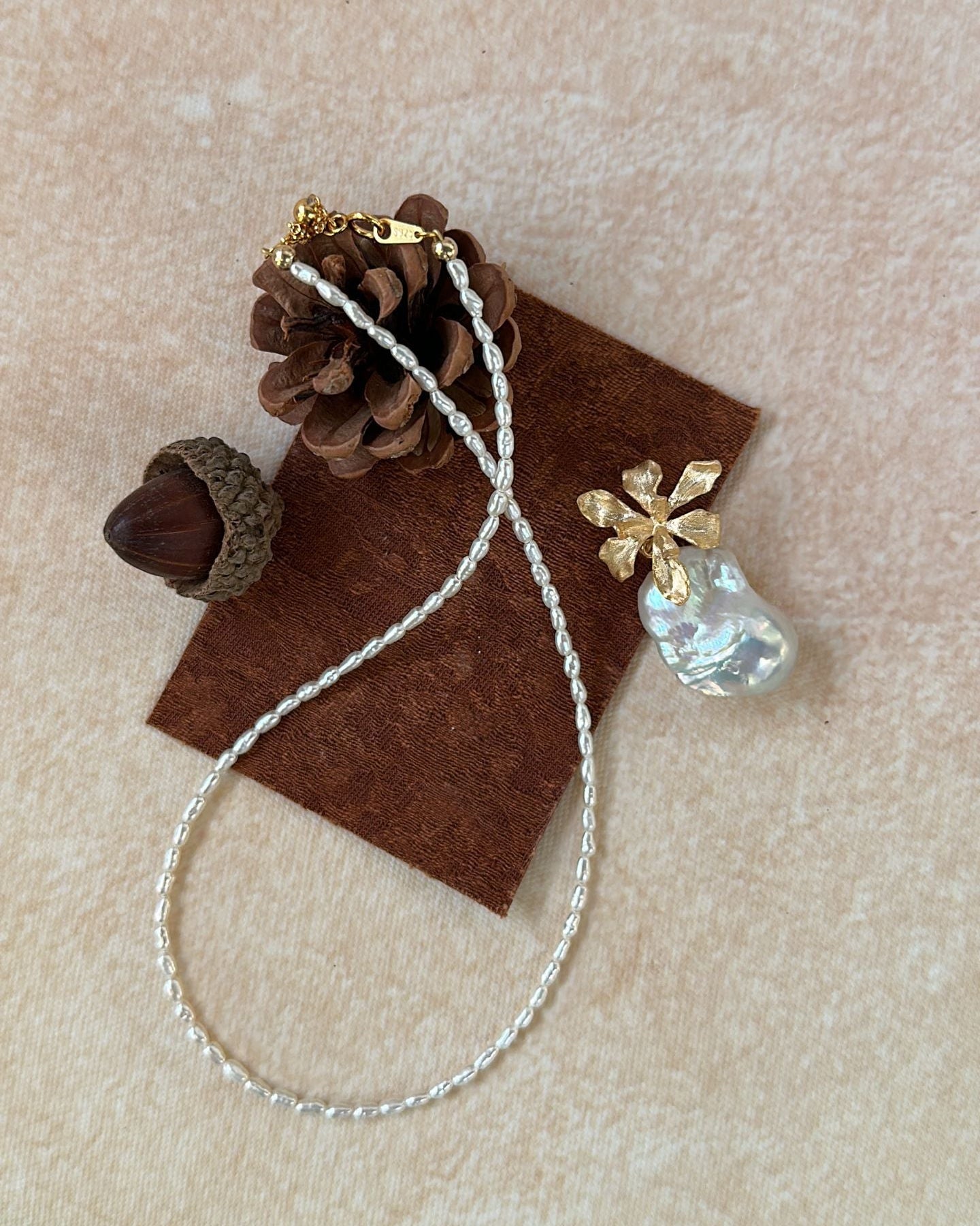 Necklace with a pendant on a brown fabric background