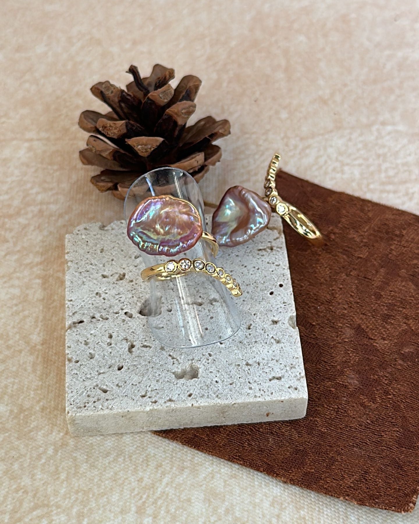 Small angel figurine with a pine cone on a textured surface