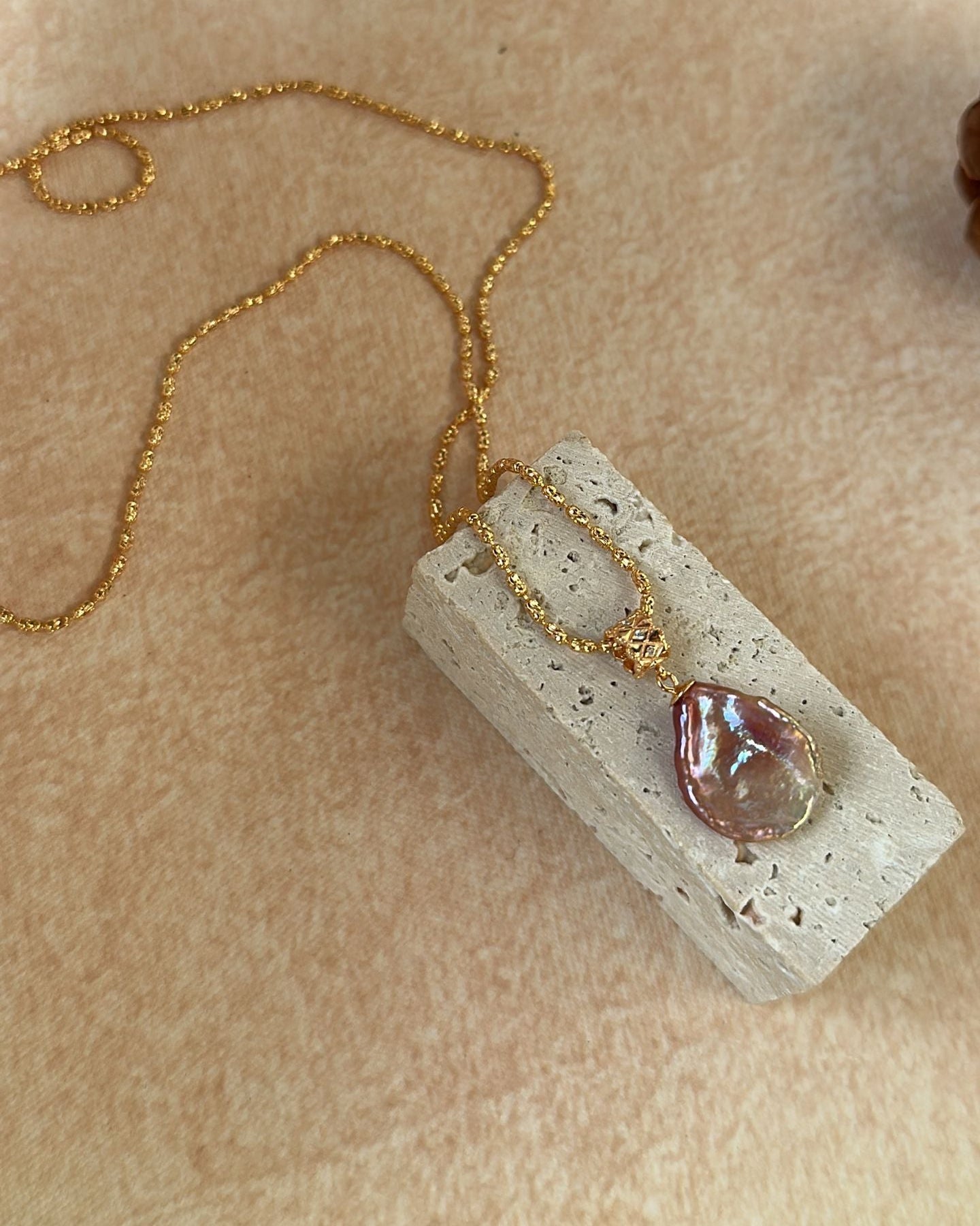 Necklace with a pendant on a textured surface