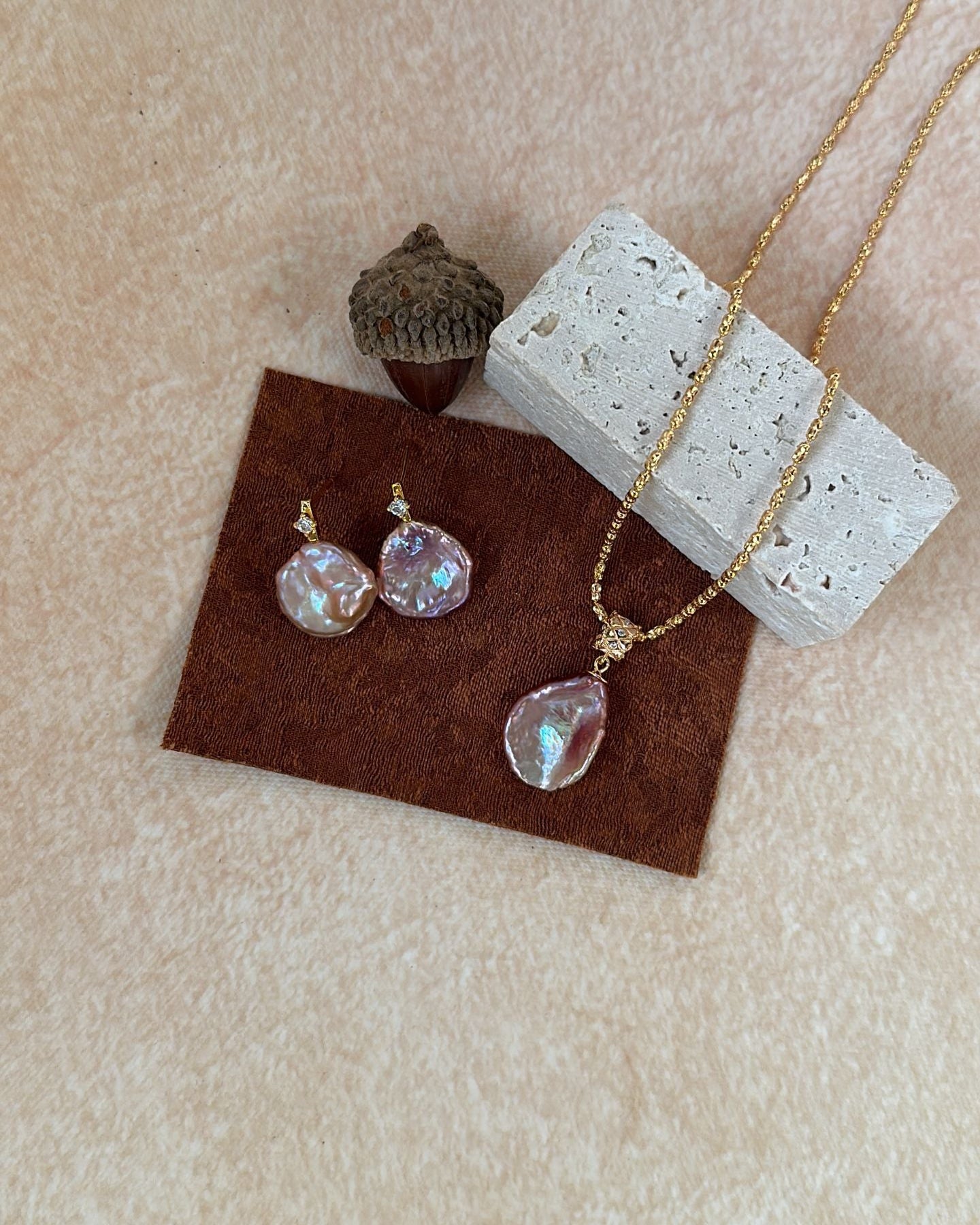 Jewelry set with necklace and earrings on a textured surface