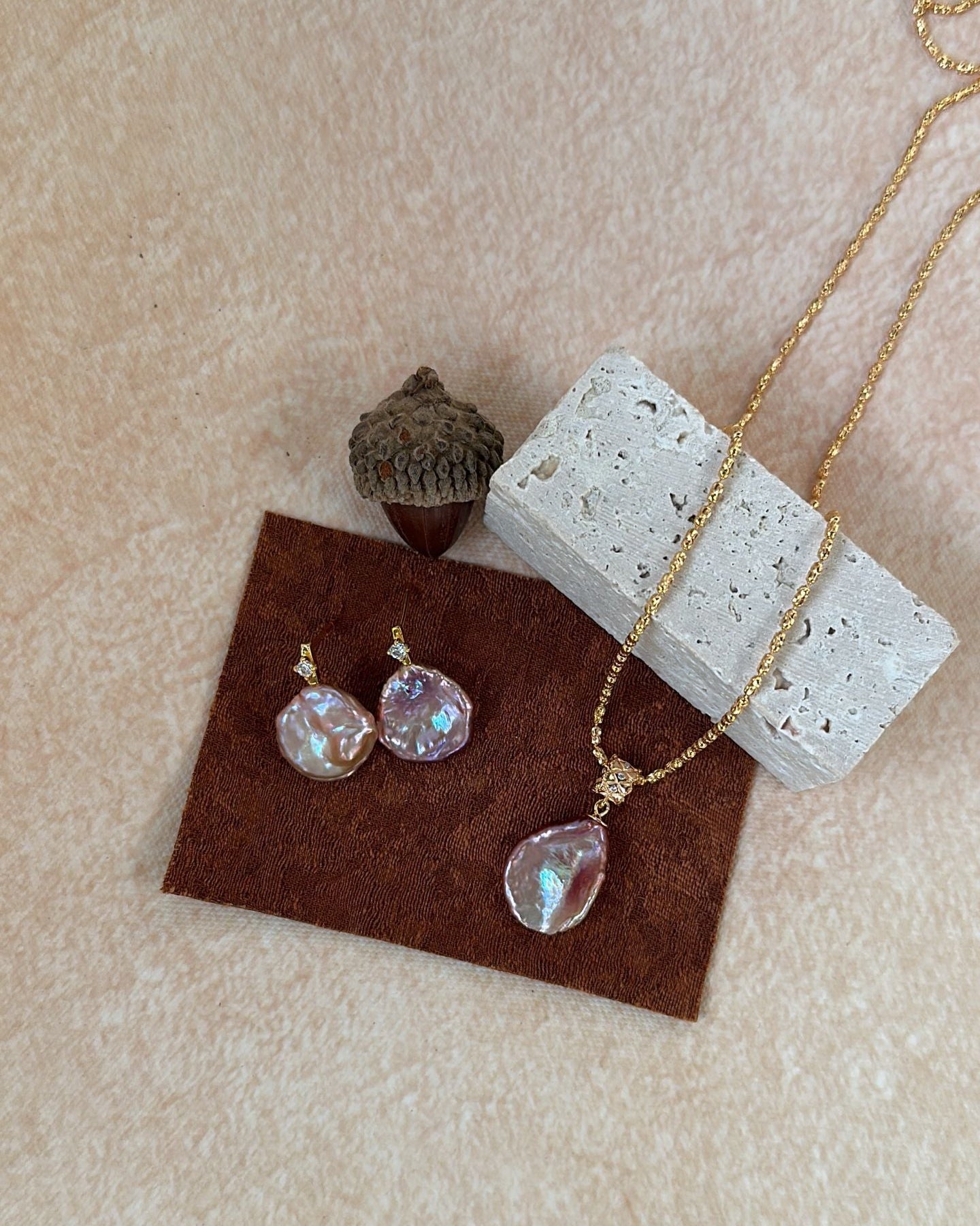 Jewelry set with necklace and earrings on a textured surface