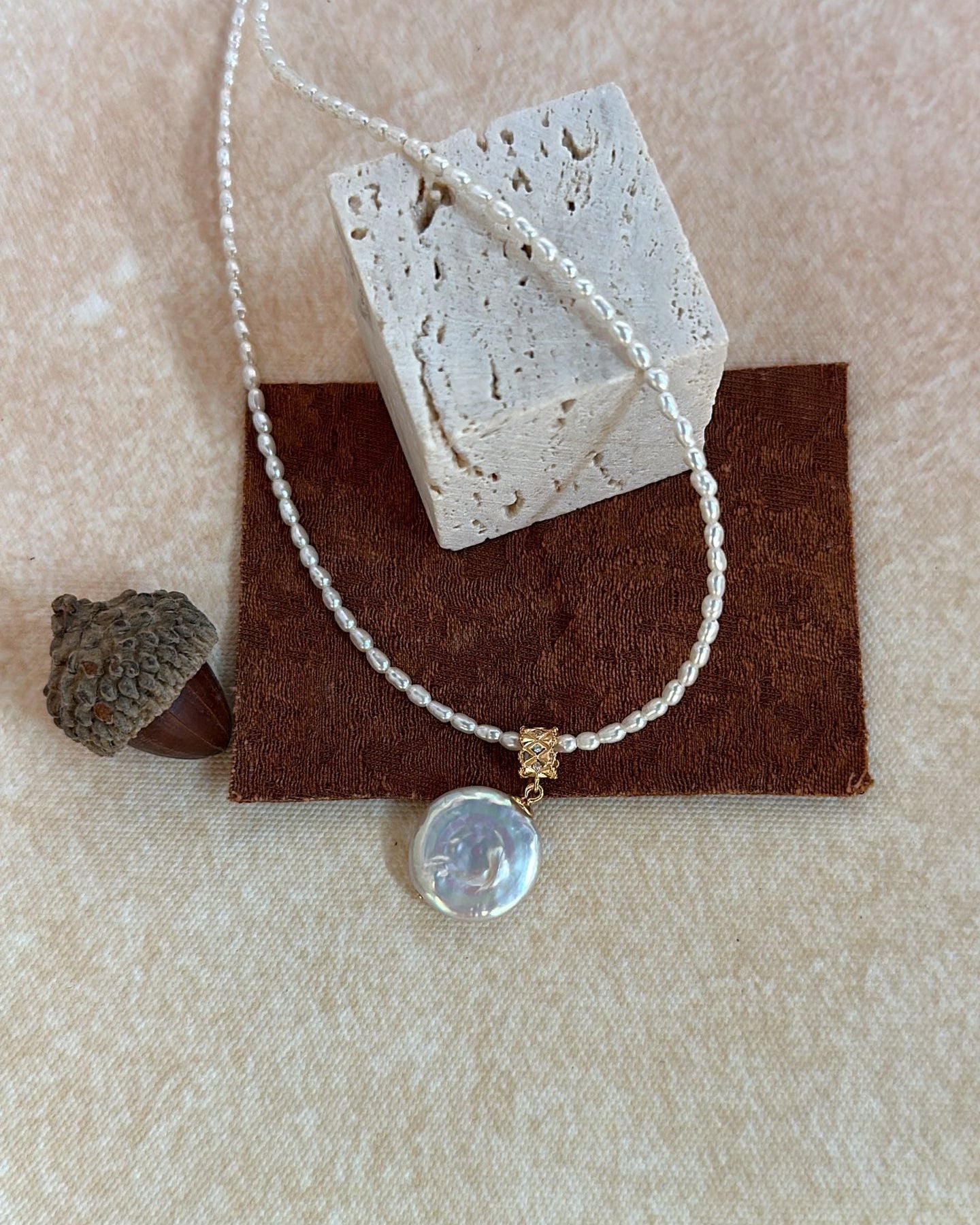 Necklace with a pendant on a textured surface